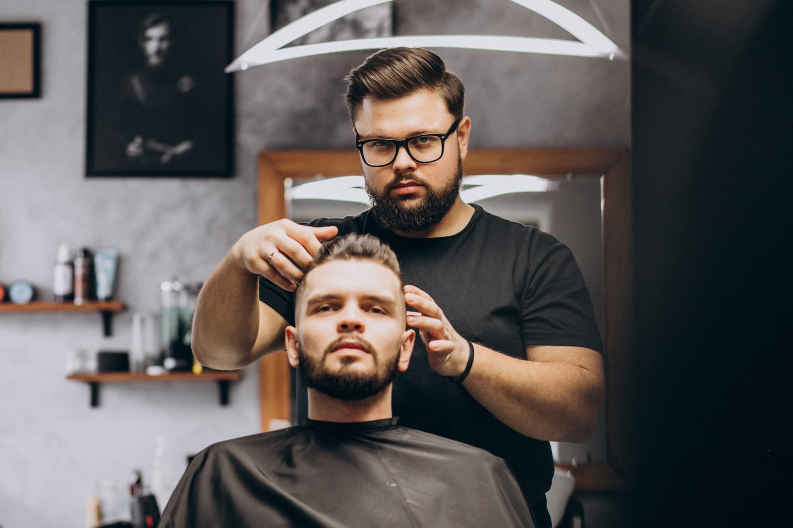 Hairdresser at a barber shop styling hair of a client